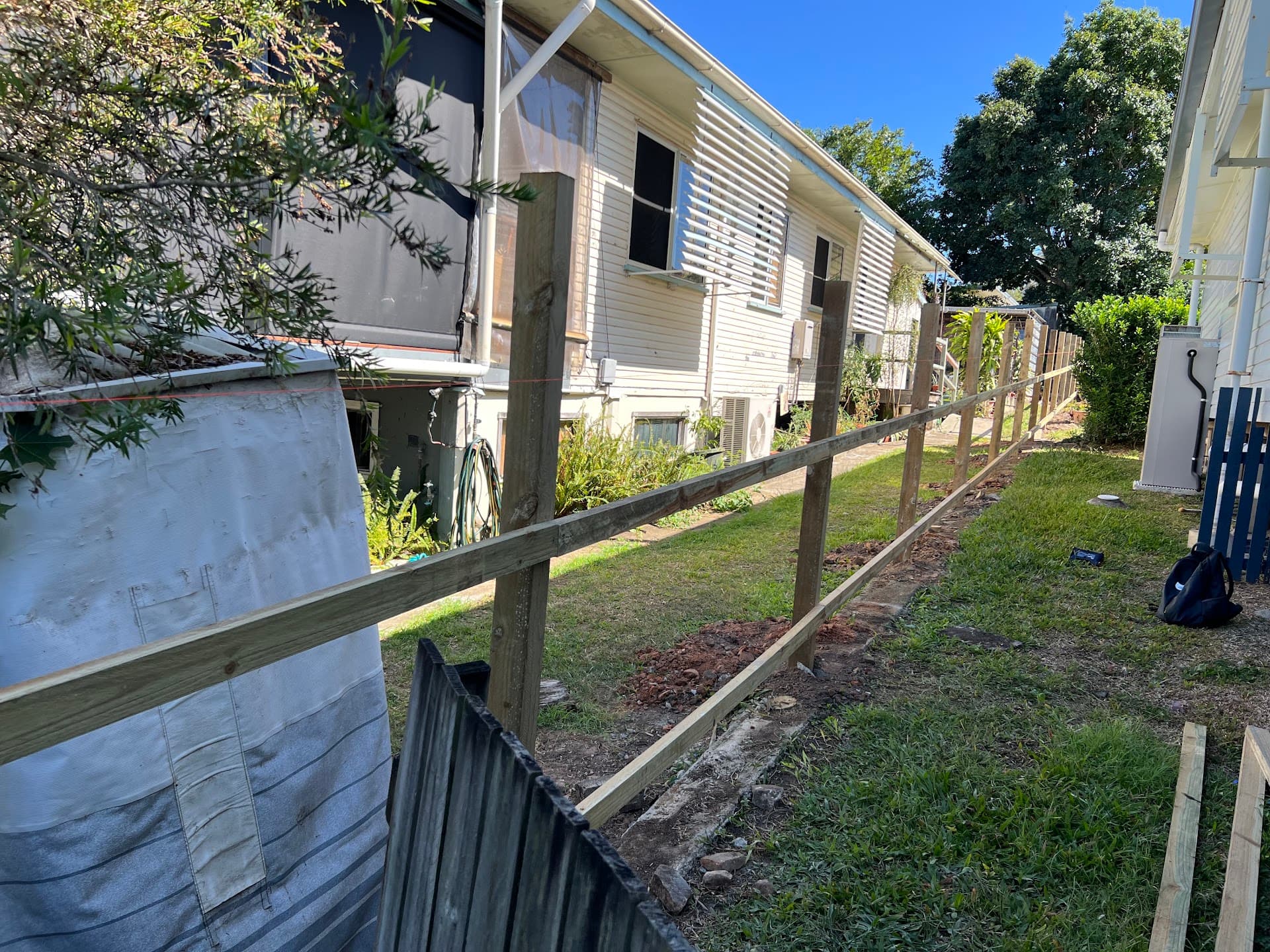 Old boundary fence being replaced with new timber posts and rails